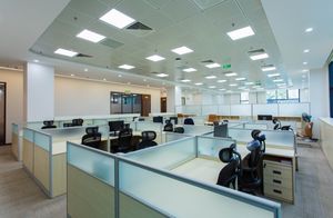 service-1 Spacious open-plan office with cubicles and modern furnishings, ideal for collaborative work environments.
